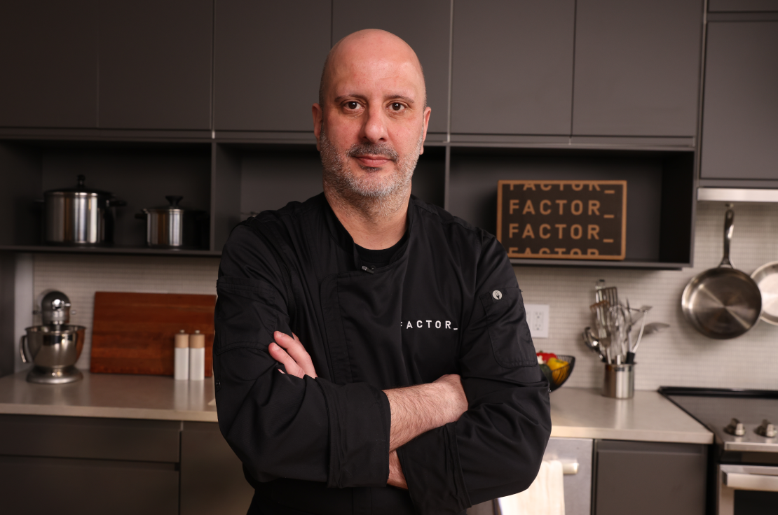 Chef Pete standing confidently with arms crossed