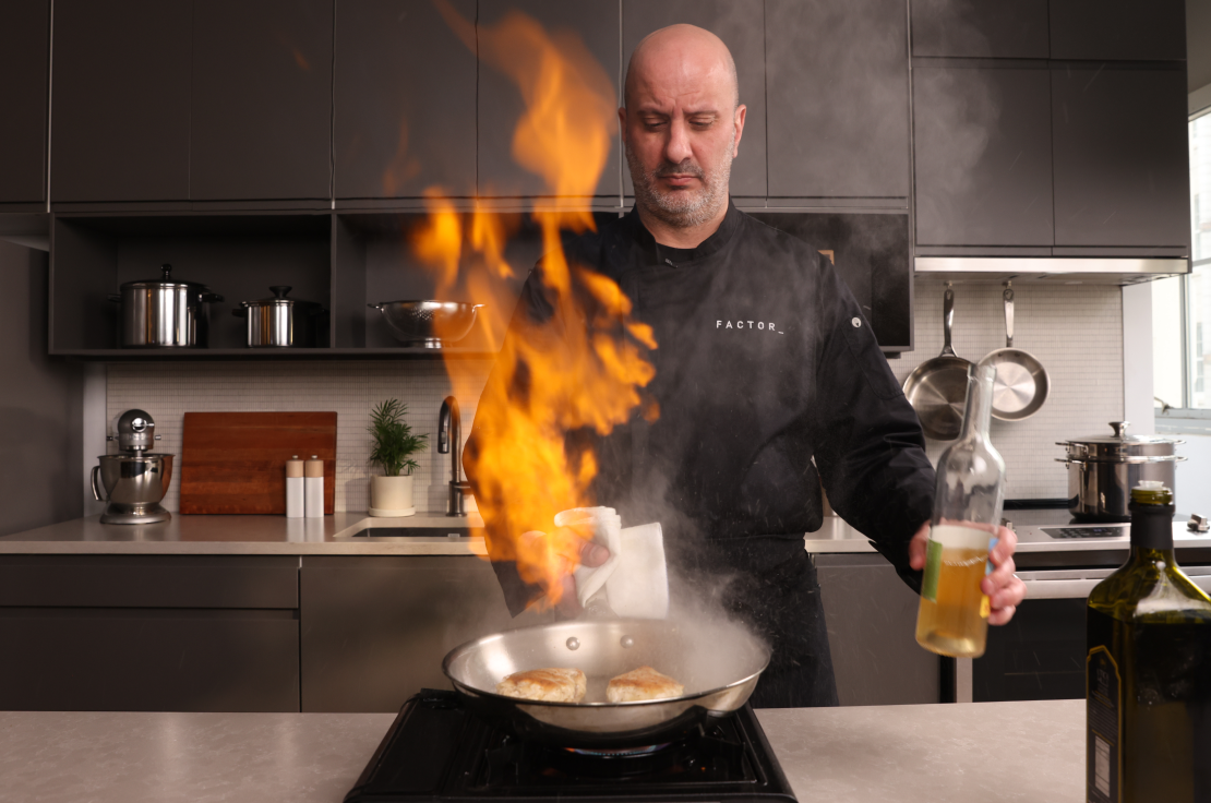 Chef Pete flambéing in the kitchen with intense fire